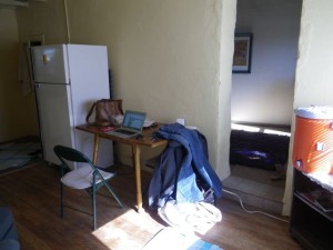 The door to the bedroom is to the right of the front door.